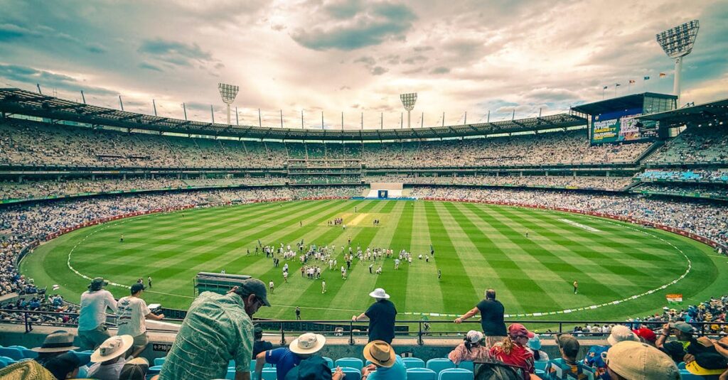 A lively cricket match at Melbourne Cricket Ground with a colorful crowd under a dynamic sky.